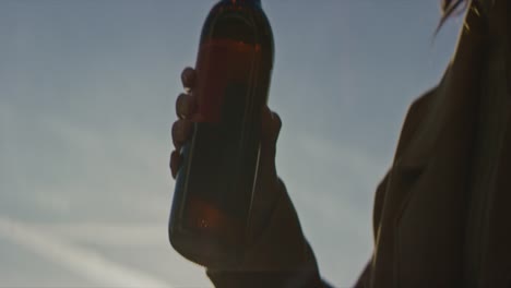Woman-drinking-a-beer-from-bottle