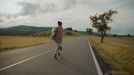 Woman-with-backpack-and-binoculars-enjoys-running-on-road