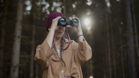Female-explorer-with-binoculars-in-forest