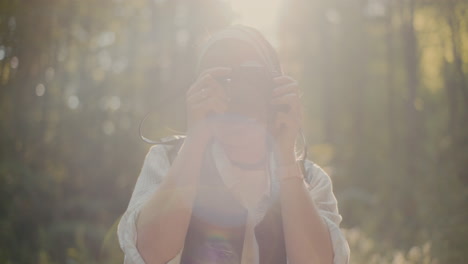 Female-Hiker-Photographing-Through-Camera-In-Forest