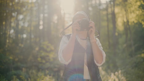 Smiling-Tourist-Photographing-Through-Camera-In-Forest