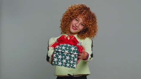 Lovely-smiling-teen-child-girl-kid-presenting-birthday-gift-box-offer-wrapped-present-celebrating