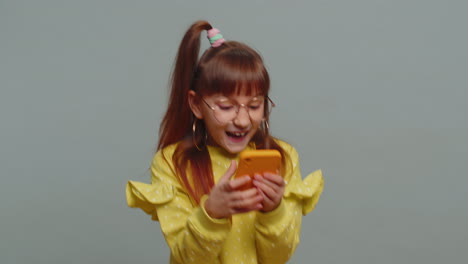 Child-girl-kid-use-mobile-smartphone-browsing-say-Wow-yes-found-out-great-win-good-news-celebrate