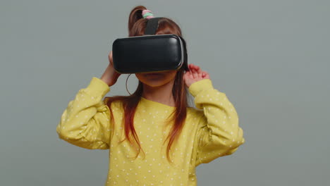 Child-kid-girl-using-headset-helmet-app-to-play-simulation-game,-watching-virtual-reality-3D-video