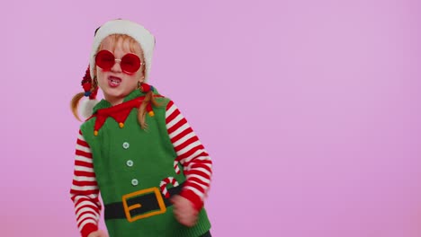 Girl-Christmas-Santa-Claus-Elf-listening-music-via-earphones-dancing-disco-fooling-around-having-fun