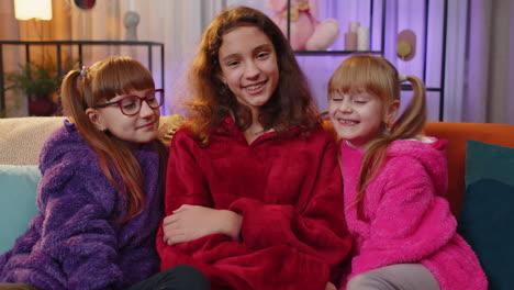 Portrait-of-happy-smiling-teenage-child-and-little-sisters-kids-looking-at-camera-at-home-play-room