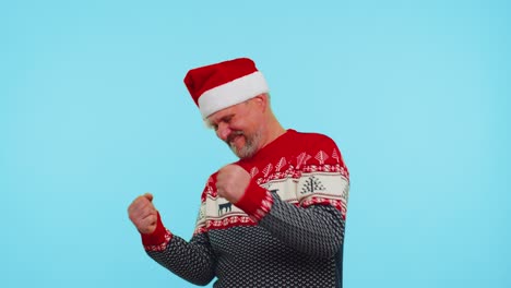 Cheerful-man-in-sweater-Christmas-Santa-shouting,-celebrating-success,-winning,-goal-achievemen