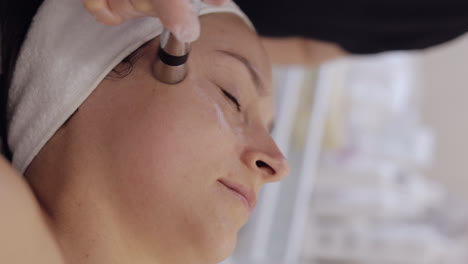 Injection-free-mesotherapy-or-electroporation,-beautician-makes-woman-face-therapy-in-clinic-salon