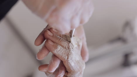 Beautician-applying-moisturizing-medical-peeling-cream-on-senior-elderly-woman-hand,-fingers,-wrist