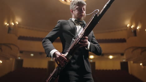 rehearsing-in-opera-house-or-philharmonic-hall-bassoonist-is-playing-music-on-scene-portrait