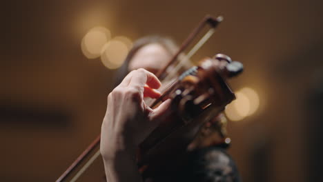 closeup-view-of-old-viola-in-hands-of-young-woman-musician-is-playing-music-on-concert