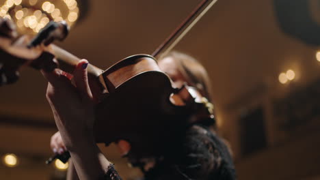female-violinist-is-playing-music-closeup-view-of-old-expensive-violin-and-female-hands