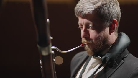 classic-musician-is-playing-bassoon-in-rehearsal-or-concert-of-symphonic-orchestra-closeup