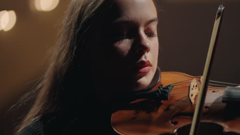 pretty-caucasian-woman-is-playing-violin-in-music-hallcloseup-portrait-of-female-violinist