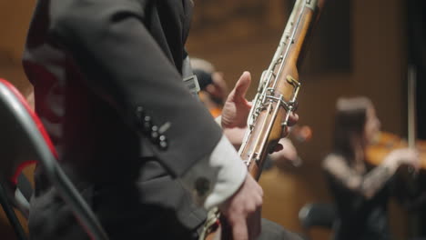 bassoon-in-small-orchestra-male-musician-is-playing-music-wind-instrument-in-hand-of-bassoonist