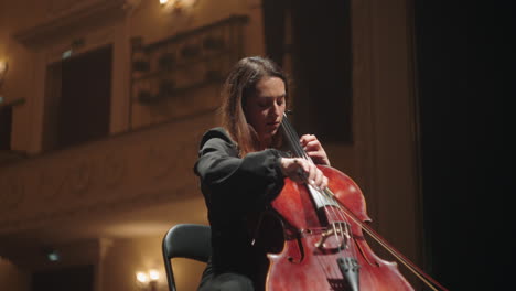 charming-and-emotional-female-violoncellist-on-scene-of-opera-house-evening-concert-of-classical-music