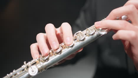 male-hands-and-flute-musician-is-playing-in-brass-band-or-symphonic-orchestra-macro-shot