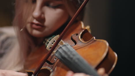 young-female-student-violinist-is-practicing-play-violin-closeup-of-old-fiddle-in-hands-of-woman-musician-is-rehearsing