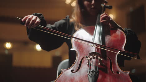 beautiful-lady-is-playing-violoncello-in-music-hall-female-cellist-is-rehearsing-on-scene