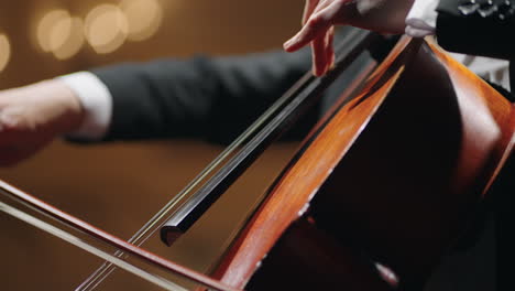 closeup-view-of-cello-professional-cellist-is-playing-violoncello-string-instrument-in-symphonic-orchestra