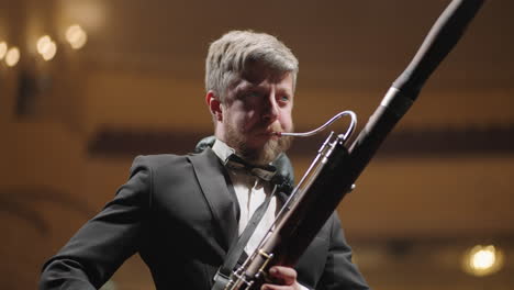 bassoon-player-is-performing-solo-in-classic-music-concert-adult-talented-man-with-bassoon