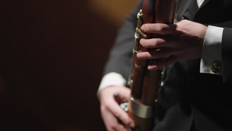 man-is-playing-bassoon-in-brass-orchestra-closeup-view-of-hands-of-bassoonist-musician-is-using-wind-instrument