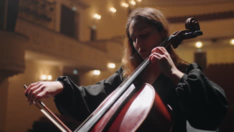 female-violoncellist-is-playing-music-in-philharmonic-hall-concert-of-classic-music-woman-cellist