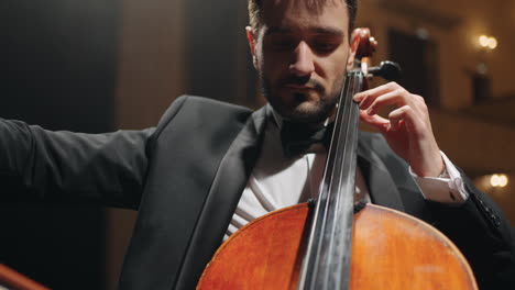 Konzentrierter-Violoncellist-Spielt-Cello-Vor-Ort-Eines-Musiksaalkonzerts-Oder-Einer-Probe-Eines-Symphonieorchesters