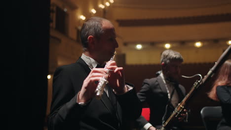 bassoonist-and-flutist-are-playign-music-in-orchestra-musicians-on-scene-of-opera-house