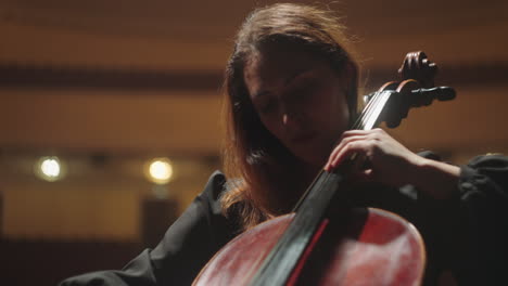 pretty-musician-woman-is-playing-violoncello-in-music-hall-female-violoncellist-on-scene-of-opera-house