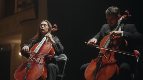 cellists-are-playing-on-scene-of-old-opera-house-orchestra-in-theater-or-philharmonic-hall