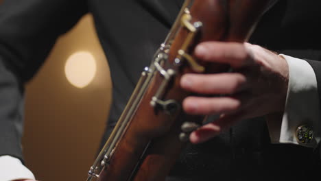 talented-bassoonist-is-playing-in-symphonic-orchestra-man-is-blowing-to-bassoon-closeup