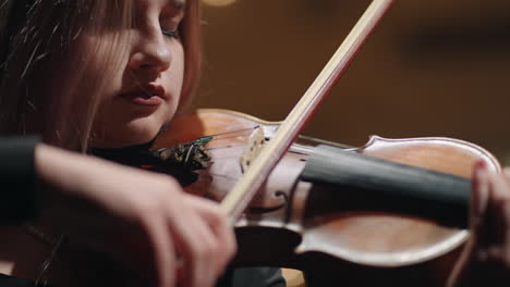 beautiful-female-violinist-is-playing-fiddle-emotionally-closeup-of-face-and-violin-concert-in-opera-house