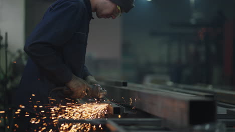 worker-grinding-a-sheet-of-metal.-Professional-mechanic-is-cutting-steel-metal.-steel-worker-metal-grinding-in-slow-motion-jobs-workforce-economy