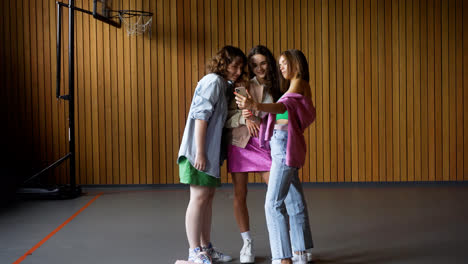 Girls-with-smartphone-on-the-school-gym