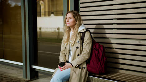 Young-woman-sitting-at-bus-stop