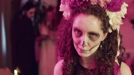 Woman-showing-her-teeth-at-camera-at-a-Halloween-party