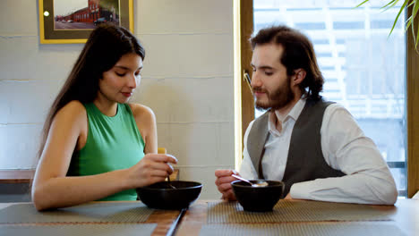 Young-couple-eating-on-a-restaurant