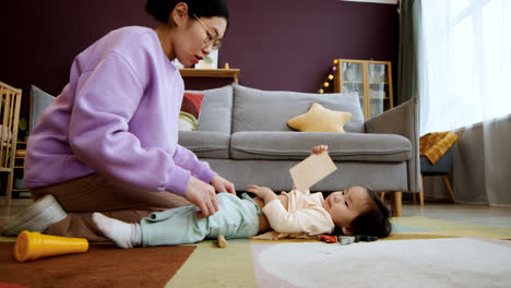 Asian-mother-playing-with-her-baby