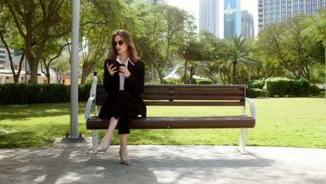 Woman-sitting-on-the-bench-of-a-park