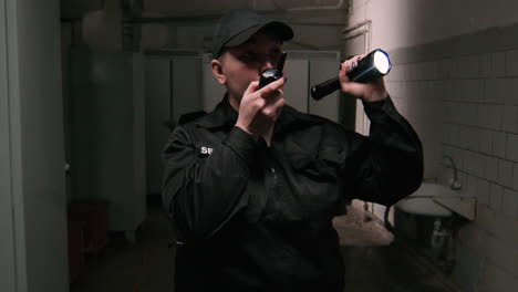 Female-safety-guard-with-flashlight-in-a-warehouse