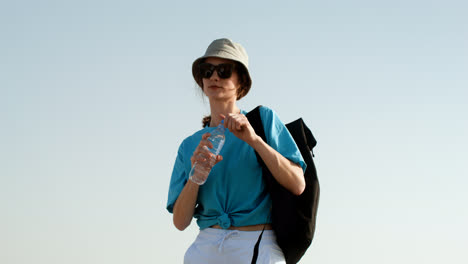 Woman-with-water-bottle-and-backpack