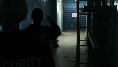Female-safety-guards-with-flashlight-in-a-warehouse