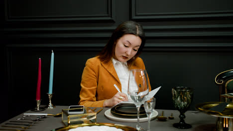 Asian-woman-sitting-at-elegant-table