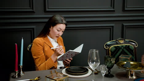 Asian-woman-sitting-at-elegant-table