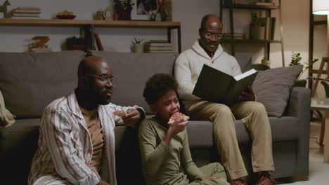 Black-men-and-boy-in-the-living-room-at-night