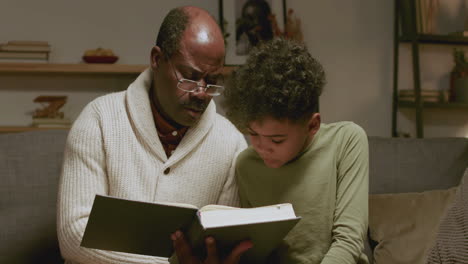 Old-black-man-and-boy-reading-a-book