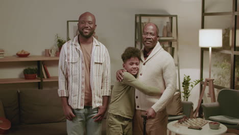 Black-men-and-boy-looking-at-the-camera-in-the-living-room
