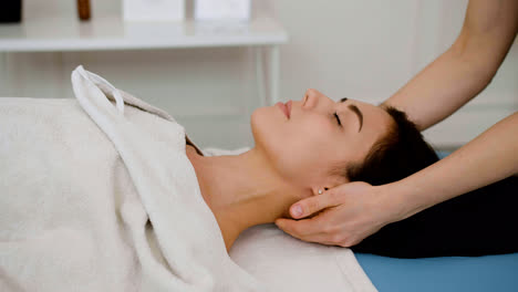 Woman-receiving-a-head-massage