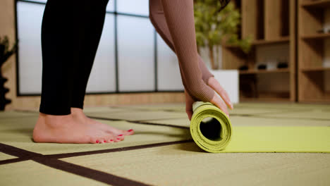 Person-rolling-the-yoga-mat